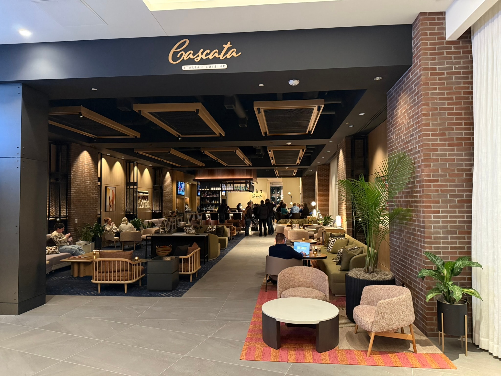 Canopy lobby overview showing staircase, mural wall, and reception area