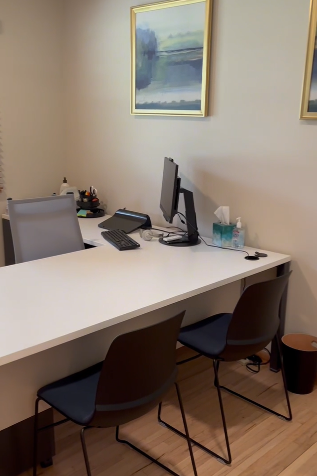 Covington private office workspace with white desk and landscape artwork