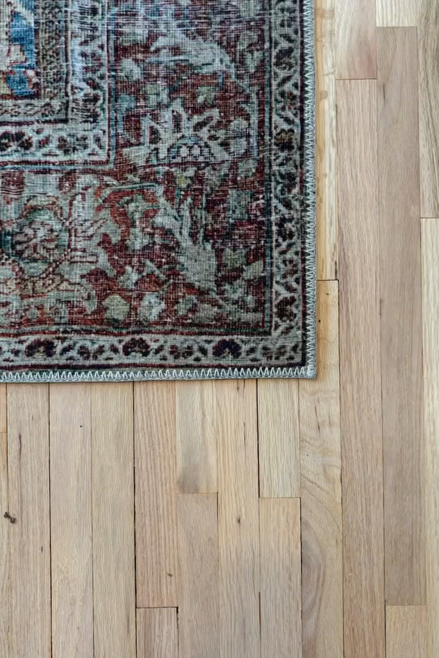 Covington ornate area rug on refinished light wood flooring