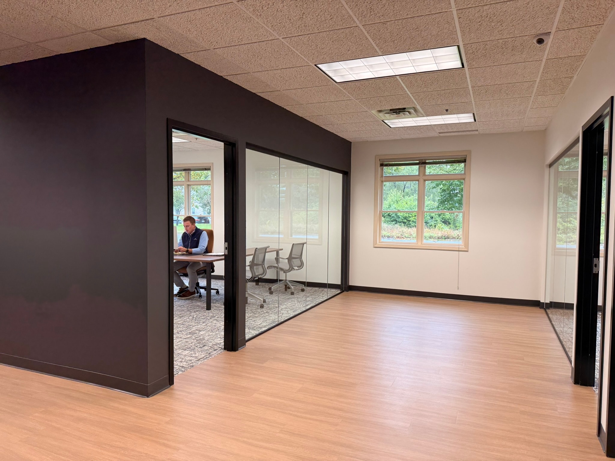 MSPA Insurance office renovation with glass partitions and dark accent walls