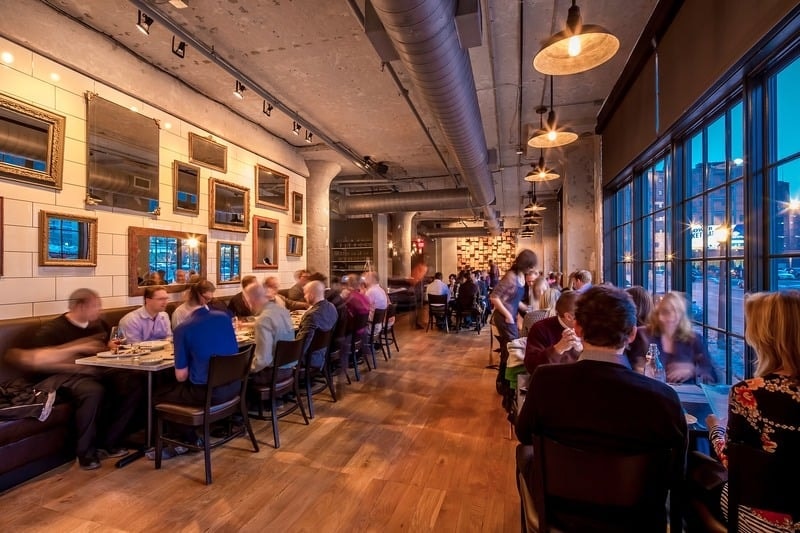 Borough - upscale bar lounge with pendant lighting, leather seating, and marble tables