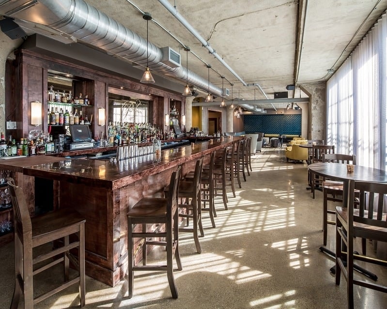 Borough - long copper bar with wood cabinetry and full back bar