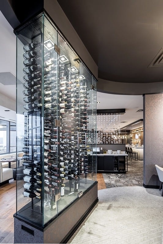 Lela Restaurant - floor-to-ceiling glass wine tower with bar and dining room beyond