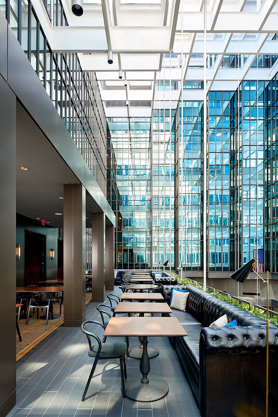 Marquette Hotel - atrium seating with tufted leather banquettes and glass curtain wall