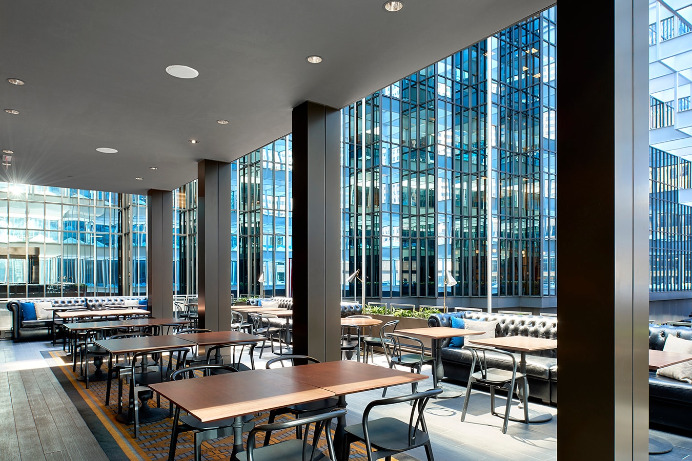 Marquette Hotel - atrium lounge with floor-to-ceiling glass and leather seating