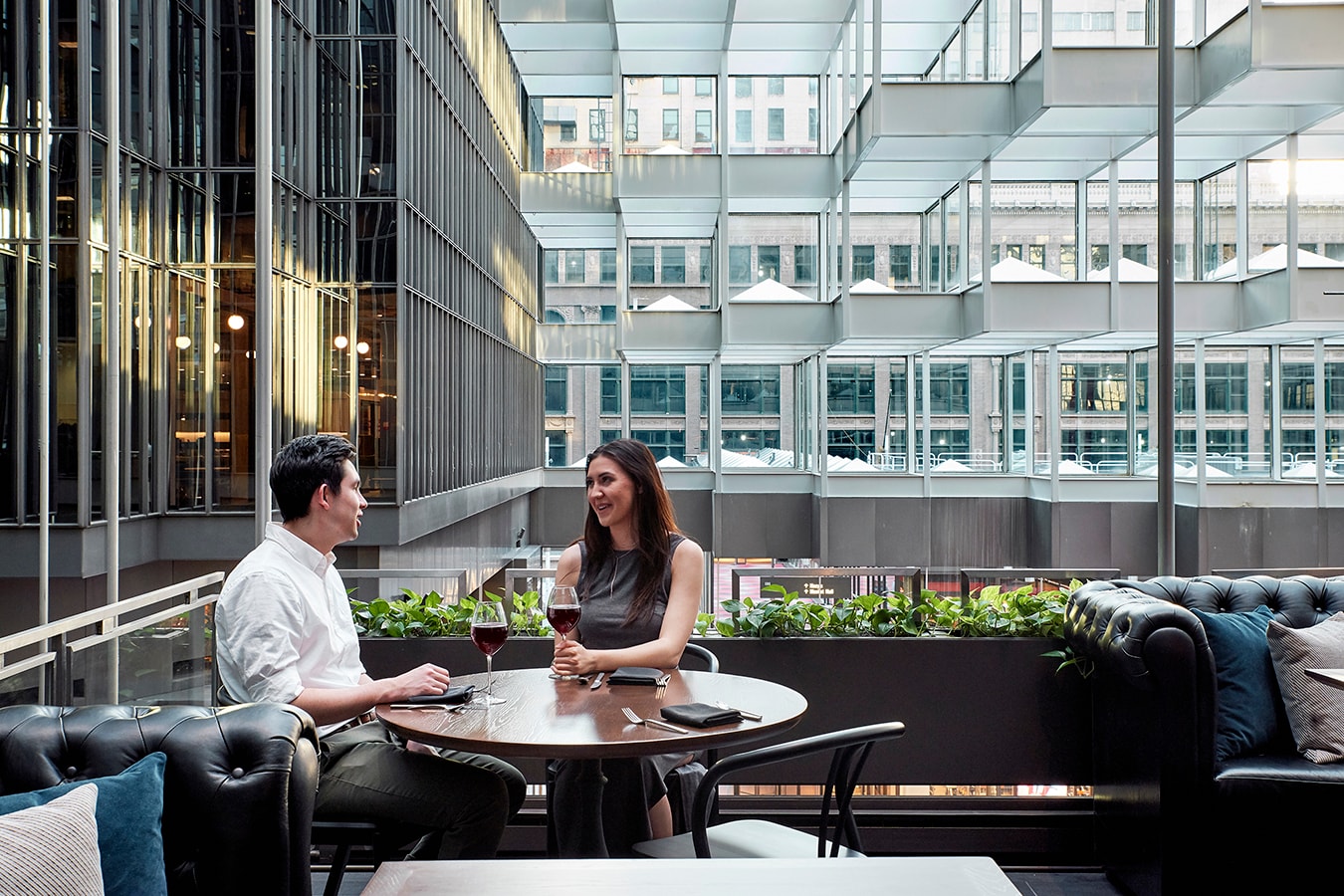 Marquette Hotel - couple dining in glass atrium with city views