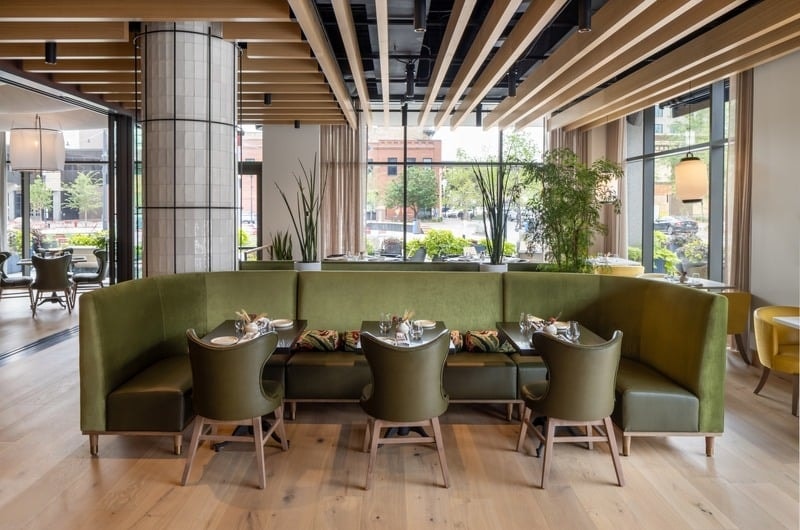 Rosewild - curved green velvet banquette with tiled column and city views