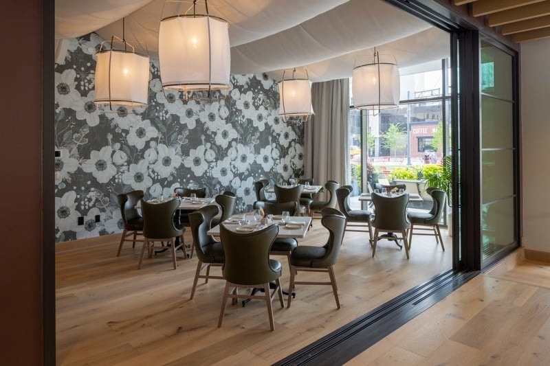 Rosewild - dining room with floor-to-ceiling windows, green and tan banquettes, and wood slat ceiling