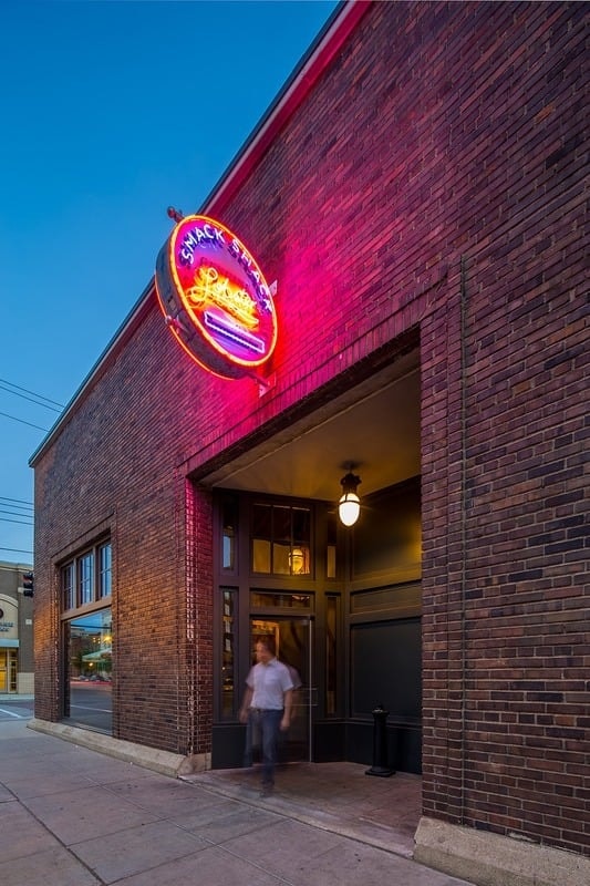 Smack Shack MPLS - exterior at dusk with glowing neon sign on brick facade