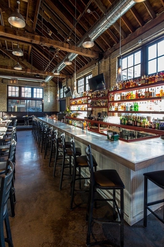 Smack Shack MPLS - busy interior with red steel mezzanine, corrugated bar, and open kitchen
