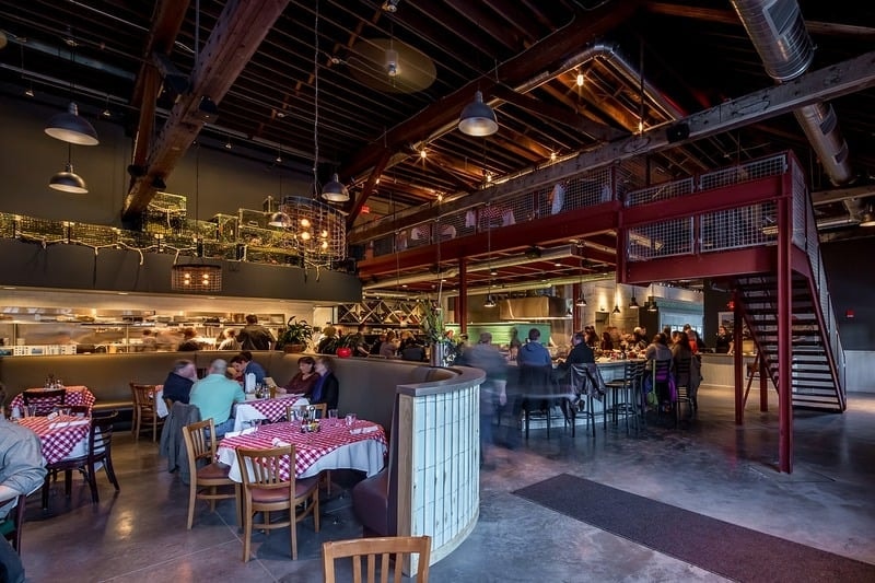 Smack Shack MPLS - entry corridor with large-scale boat blueprint mural and industrial railing