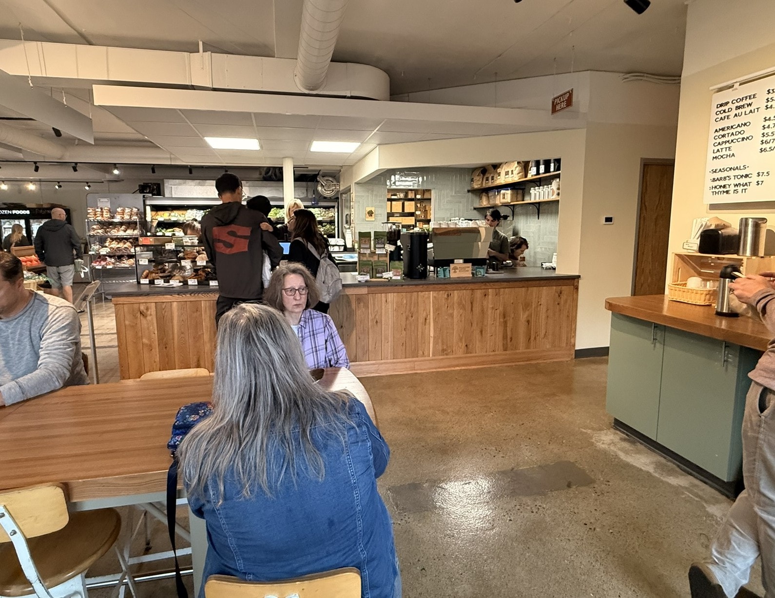 Radish Farm Stop coffee counter with wood cladding, menu board, and café seating
