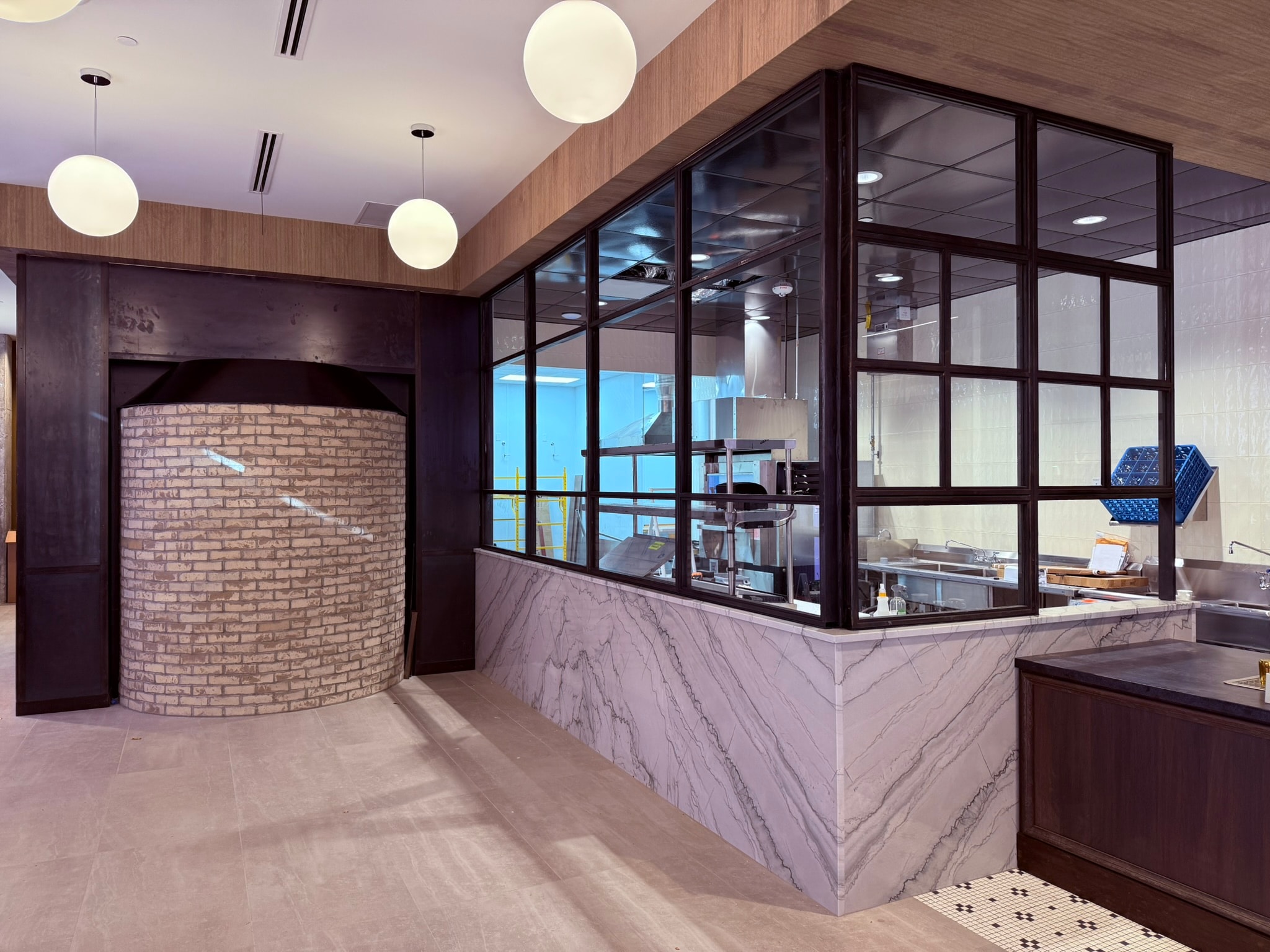 Bookmatched marble counter detail with mosaic tile floor