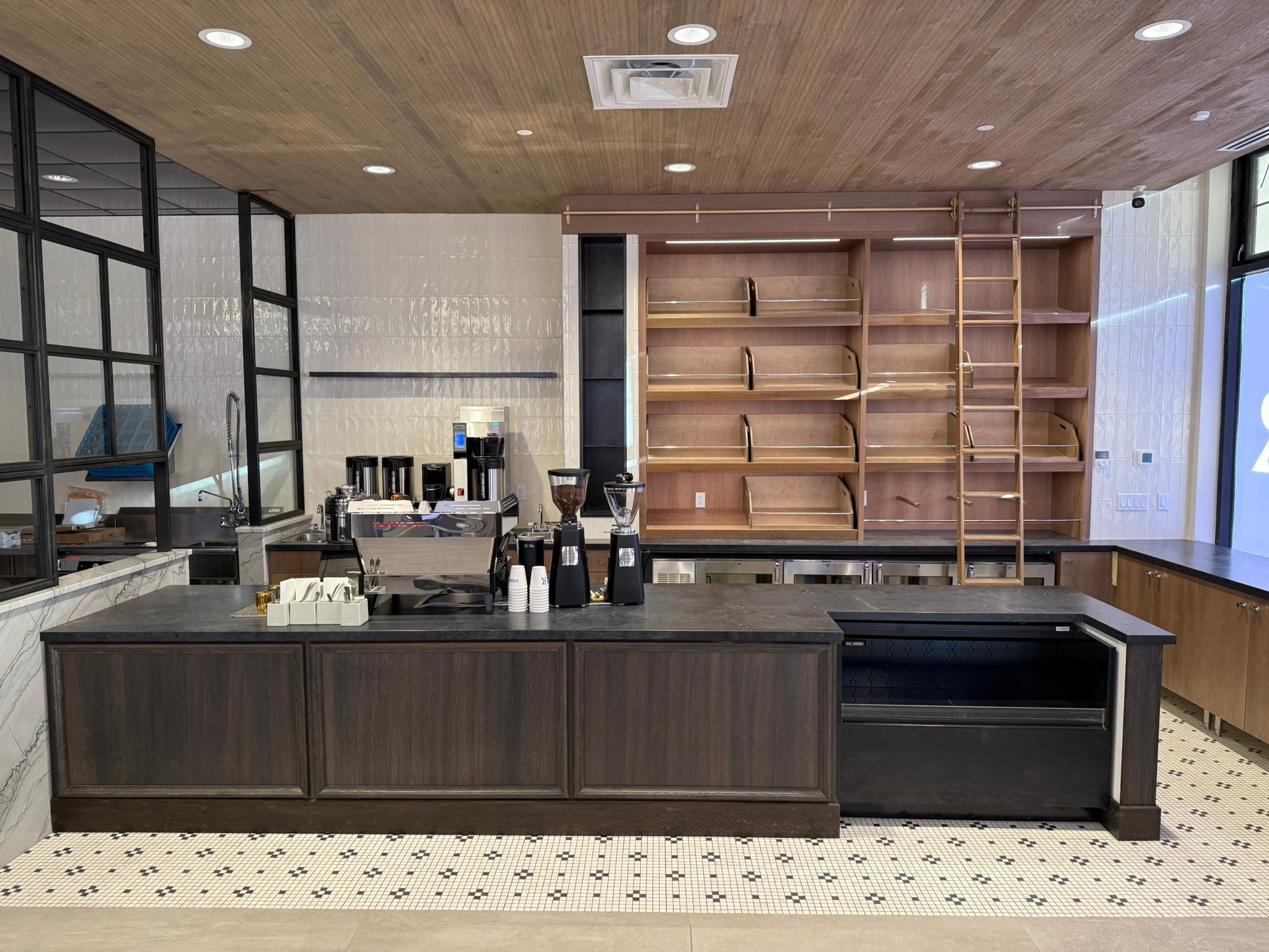 Coffee bar and bread display shelving with wood ceiling