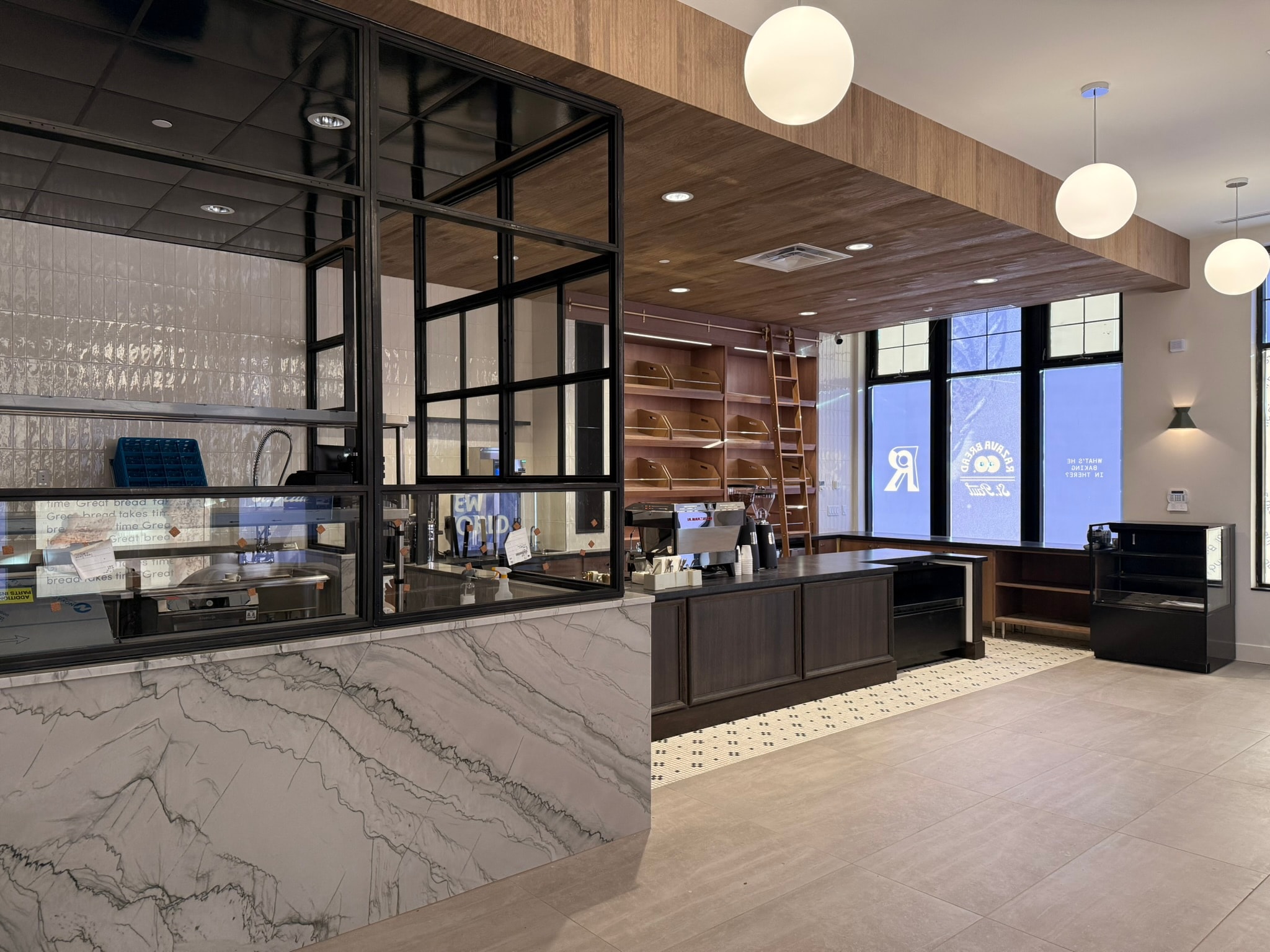 Full interior view showing counter, oven, and pendant lighting