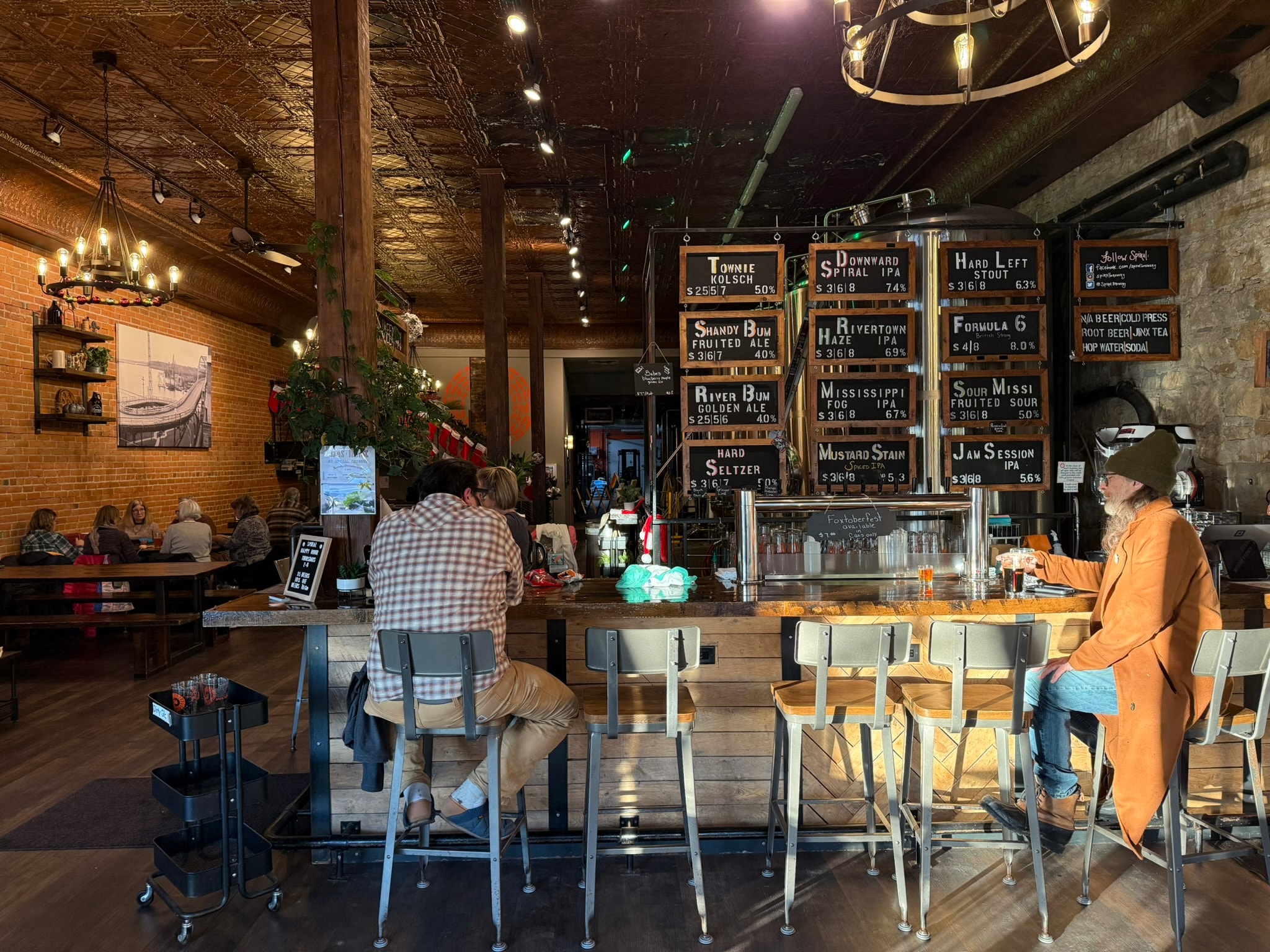 Spiral Brewery bar with chalkboard beer menu, brick wall, and pendant lighting